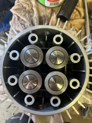 Close-up of new pump pistons installed during servicing of a Nilfisk SH Truck Booster, showing clean surfaces ready for reliable operation.